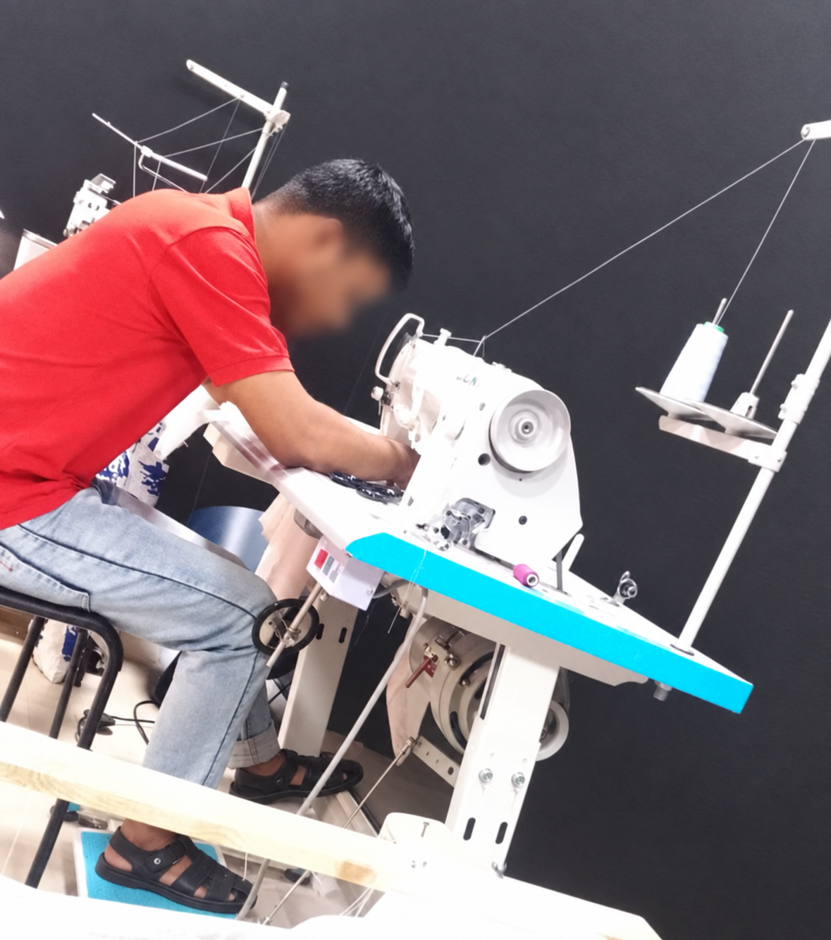 AFW professional tailor sewing a custom garment for Qatar home tailoring service