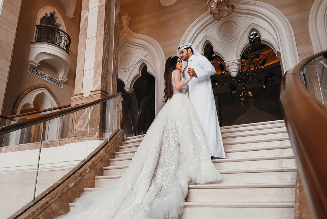 Real AFW bride wearing the Arabian Royal luxury lace wedding gown with dramatic train in Qatar