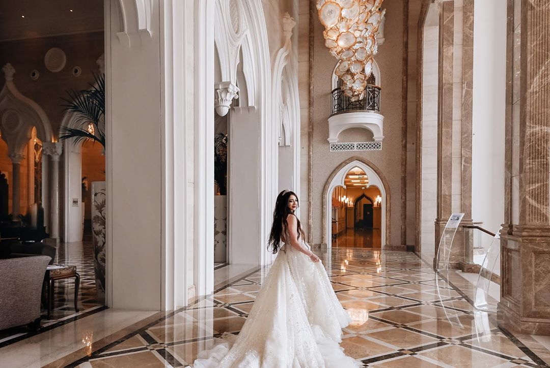 Real AFW bride wearing a custom lace bridal gown at an elegant Qatar wedding venue