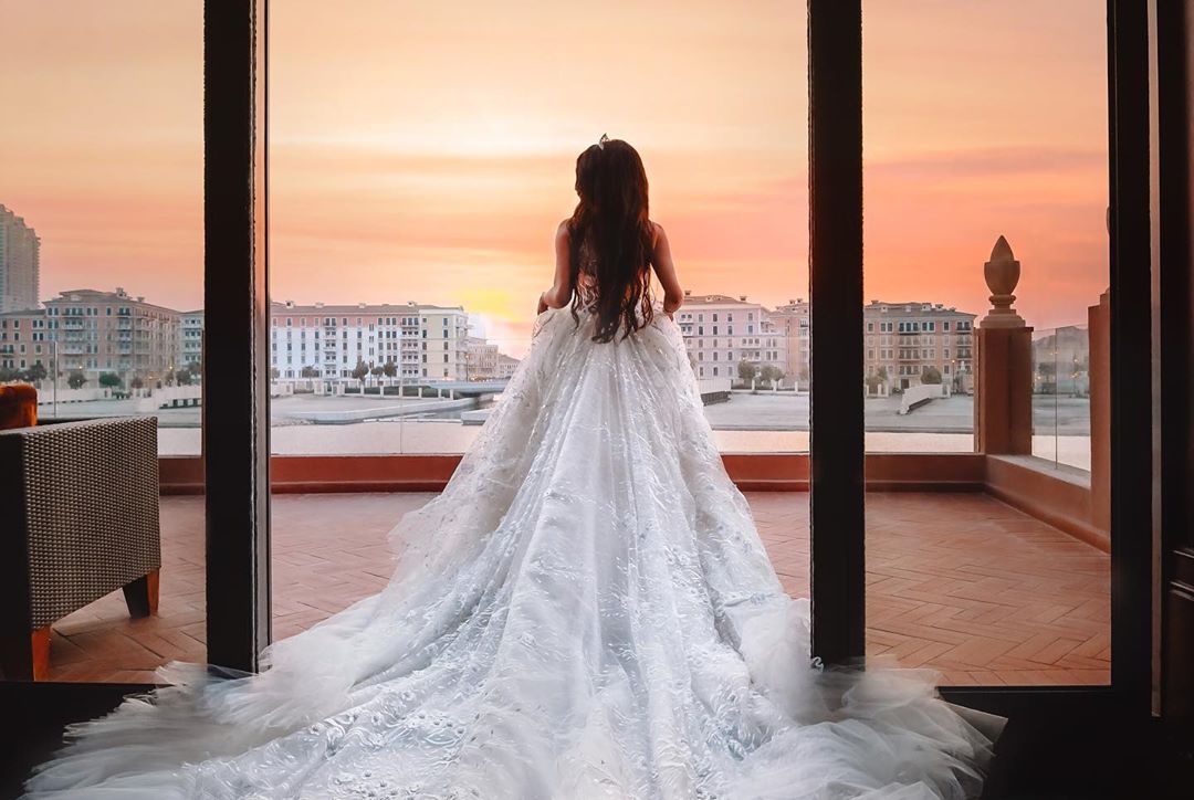 Dramatic long bridal train with intricate lace detailing and soft tulle layers