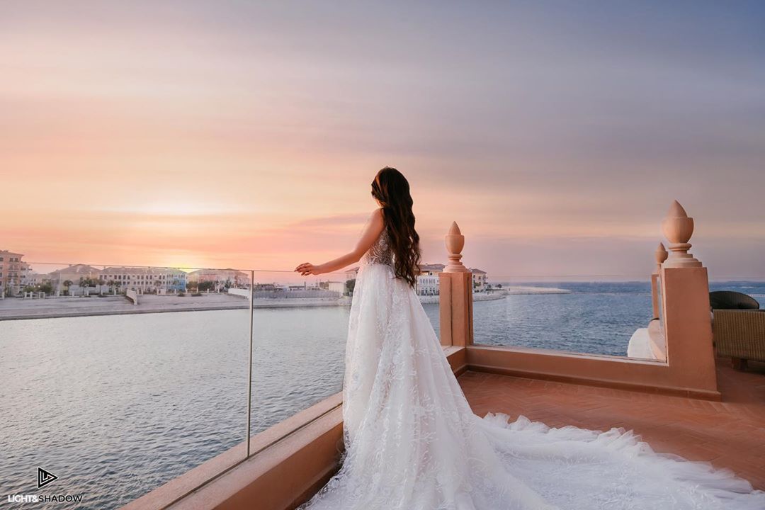 Fitted lace wedding gown opening into a dramatic long bridal train