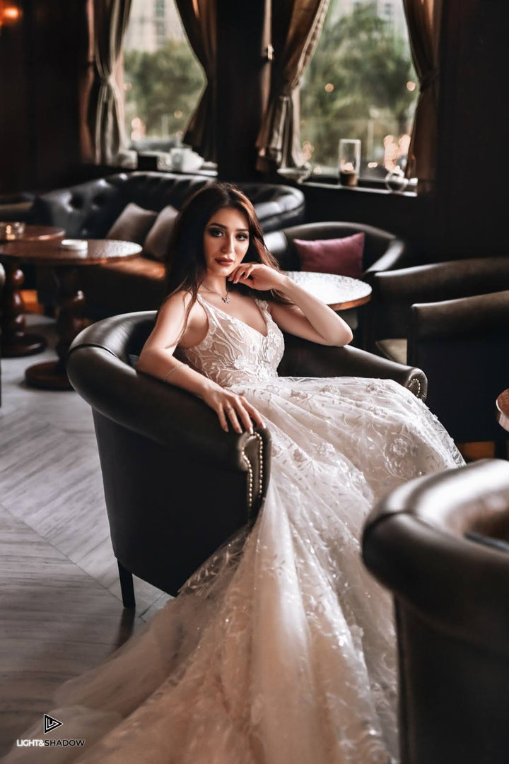 Detail view of lace and tulle bridal gown with intricate lace embellishment