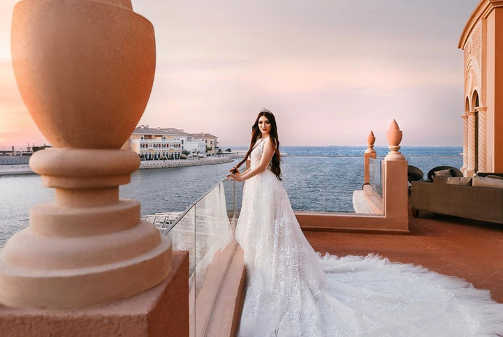 Back view of lace wedding dress with long flowing tulle bridal train